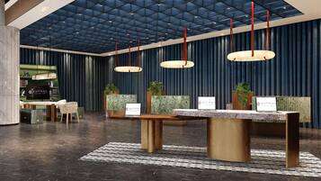 A modern reception area with a dark blue ceiling, a reception desk, and a seating area with chairs and a table.