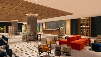 Een hotel lobby met een receptiebalie, een zithoek en een bar.