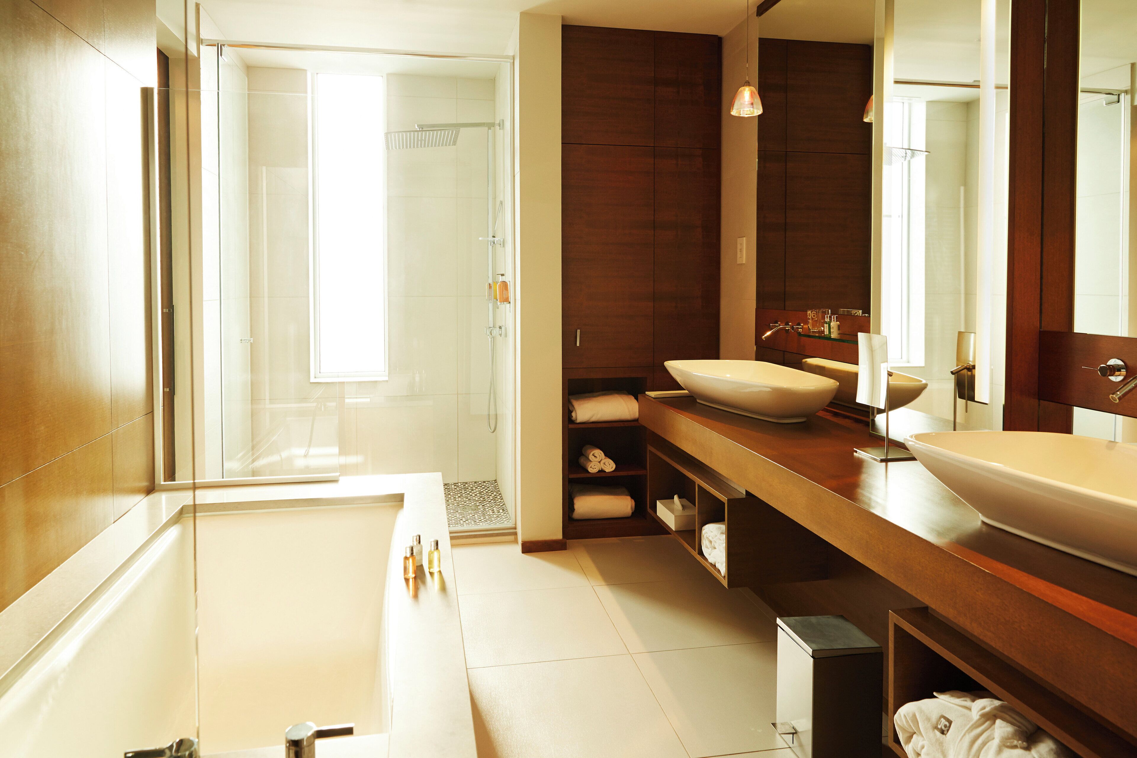 Een moderne badkamer met een groot bad, een wastafel met dubbele wastafel en een inloopdouche.