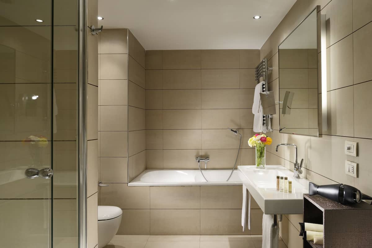 designer toiletries, hair dryer, slippers, bidet