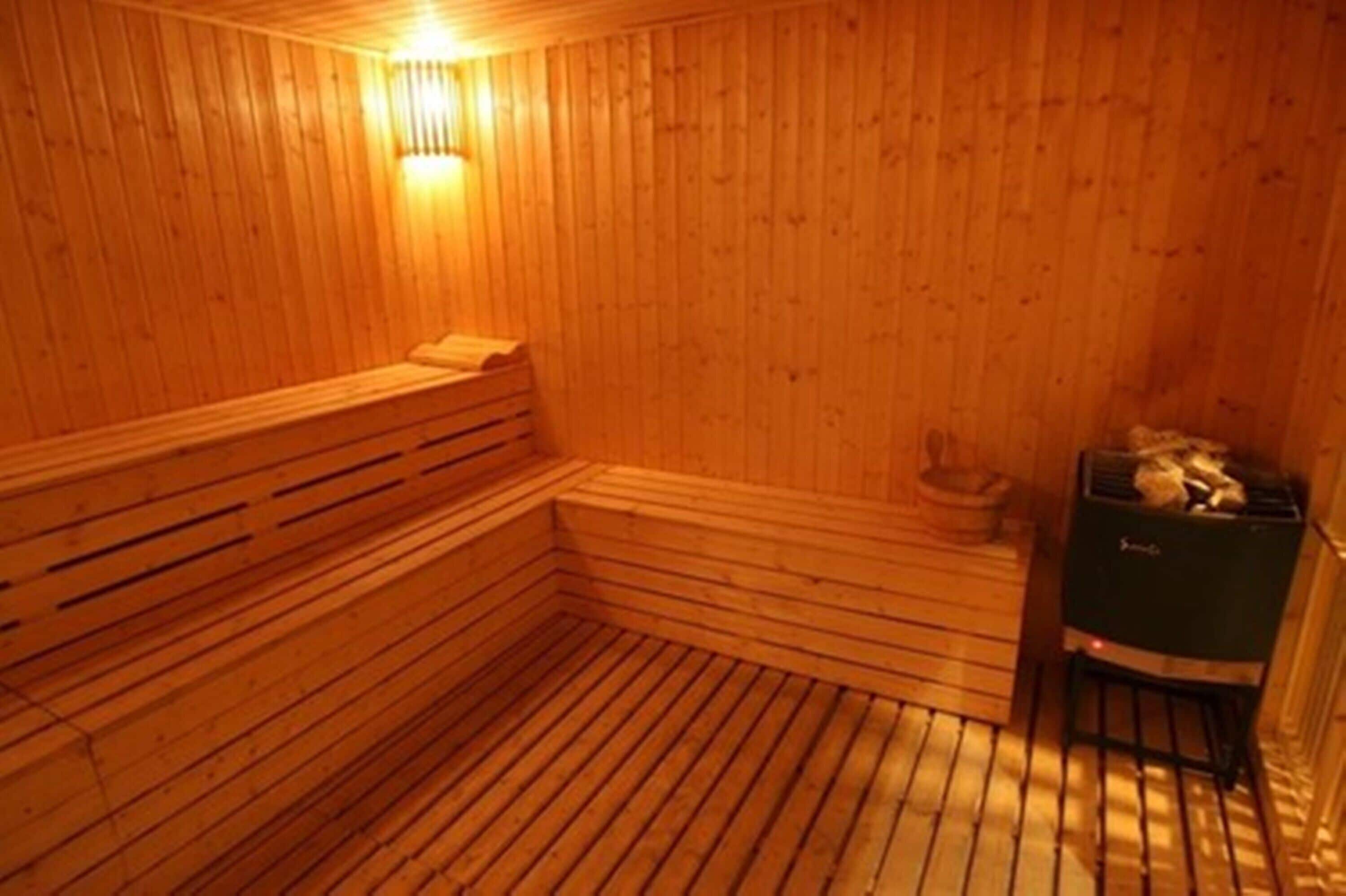 A wooden sauna with benches and a bench seat, a bench seat, and a bench.