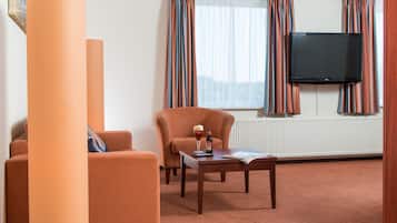 Deluxe Double Room | Living area | 43-inch LCD TV with cable channels, TV