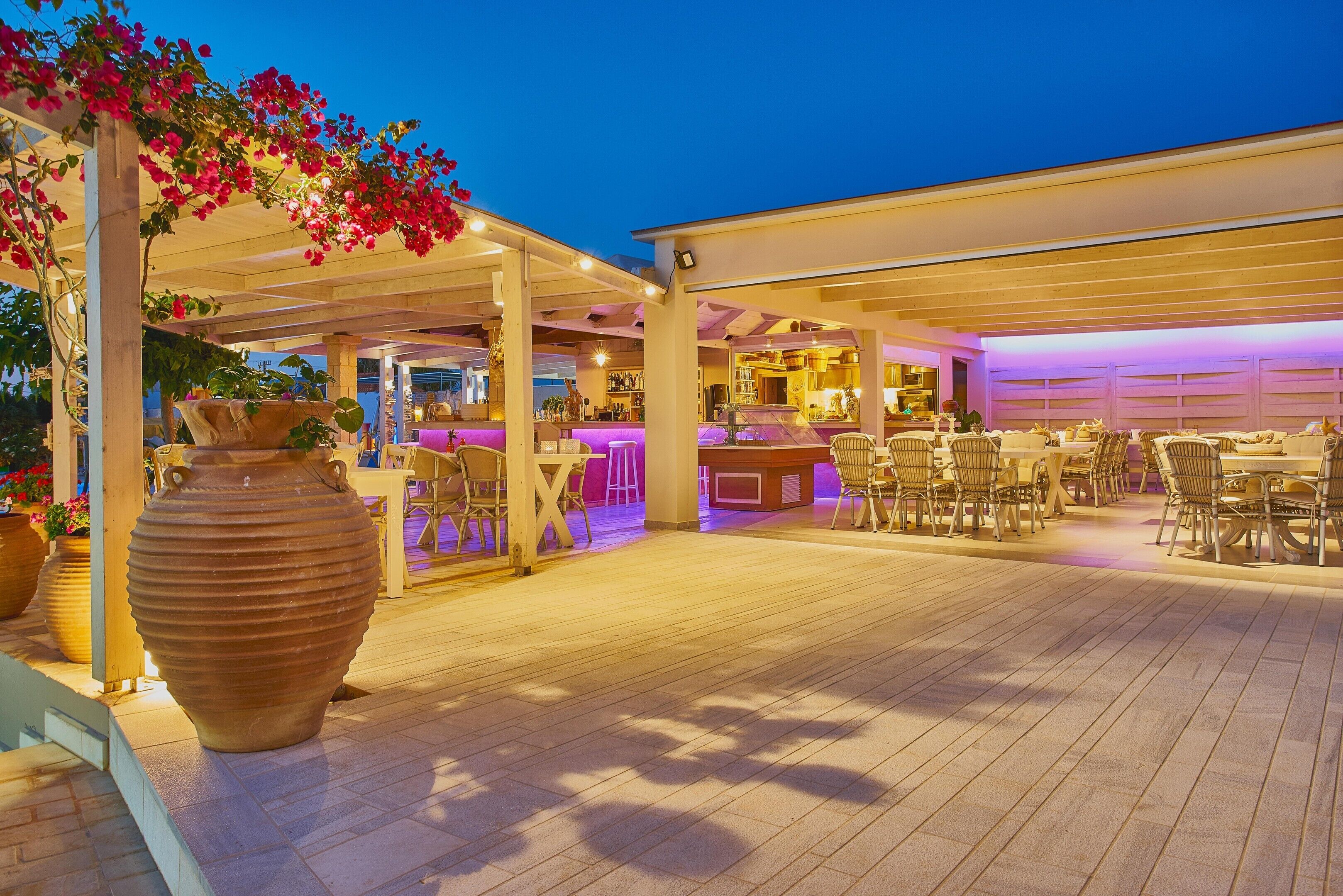 An outdoor patio area with seating, a bar, and a large vase.