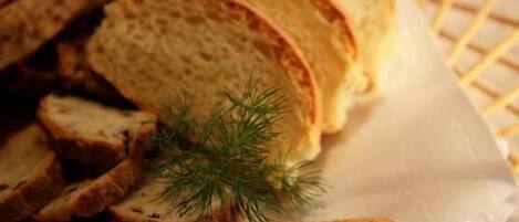 Slices of toasted bread on a white plate with a sprig of dill.