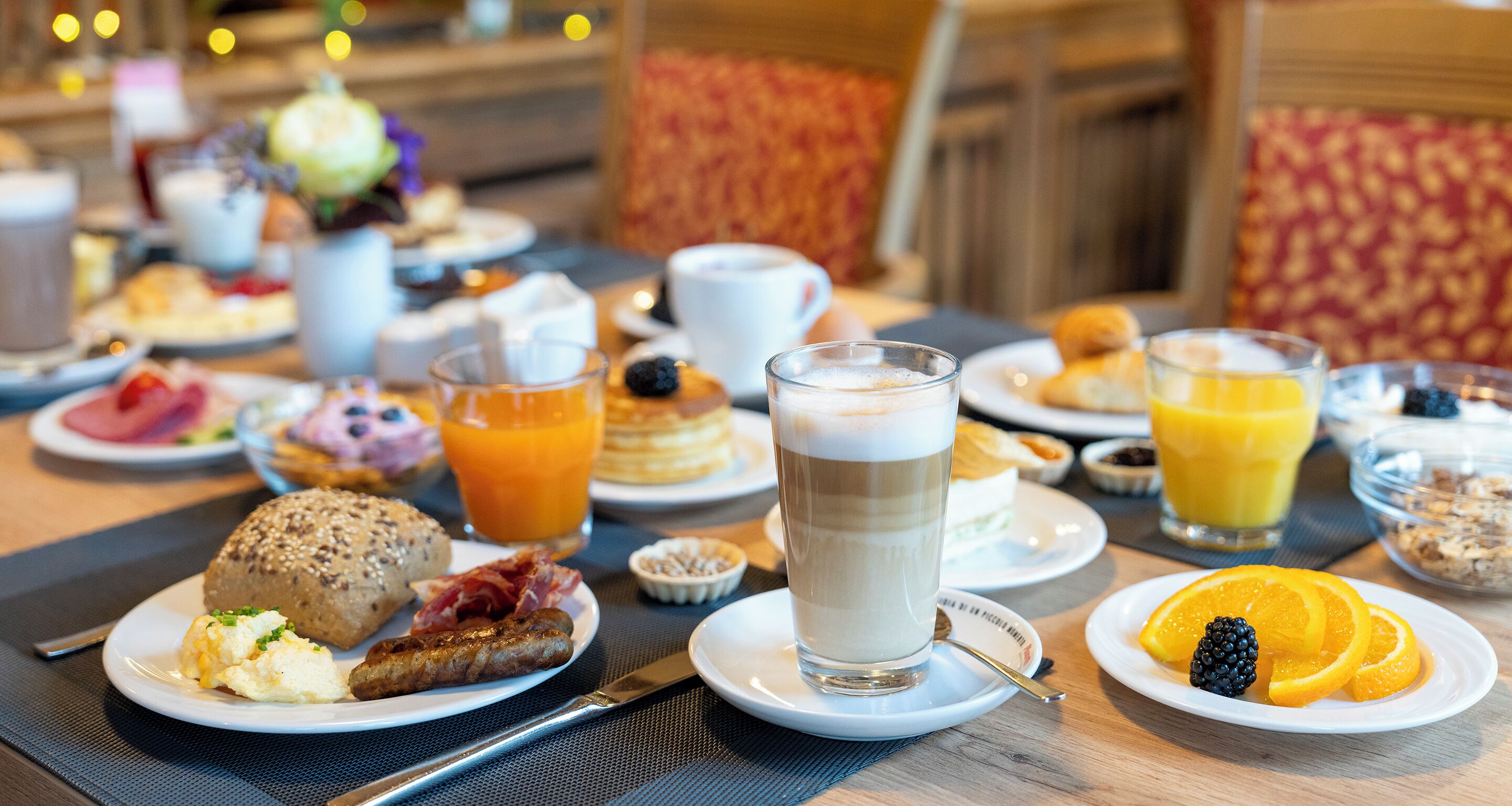 A breakfast buffet with various dishes and beverages.