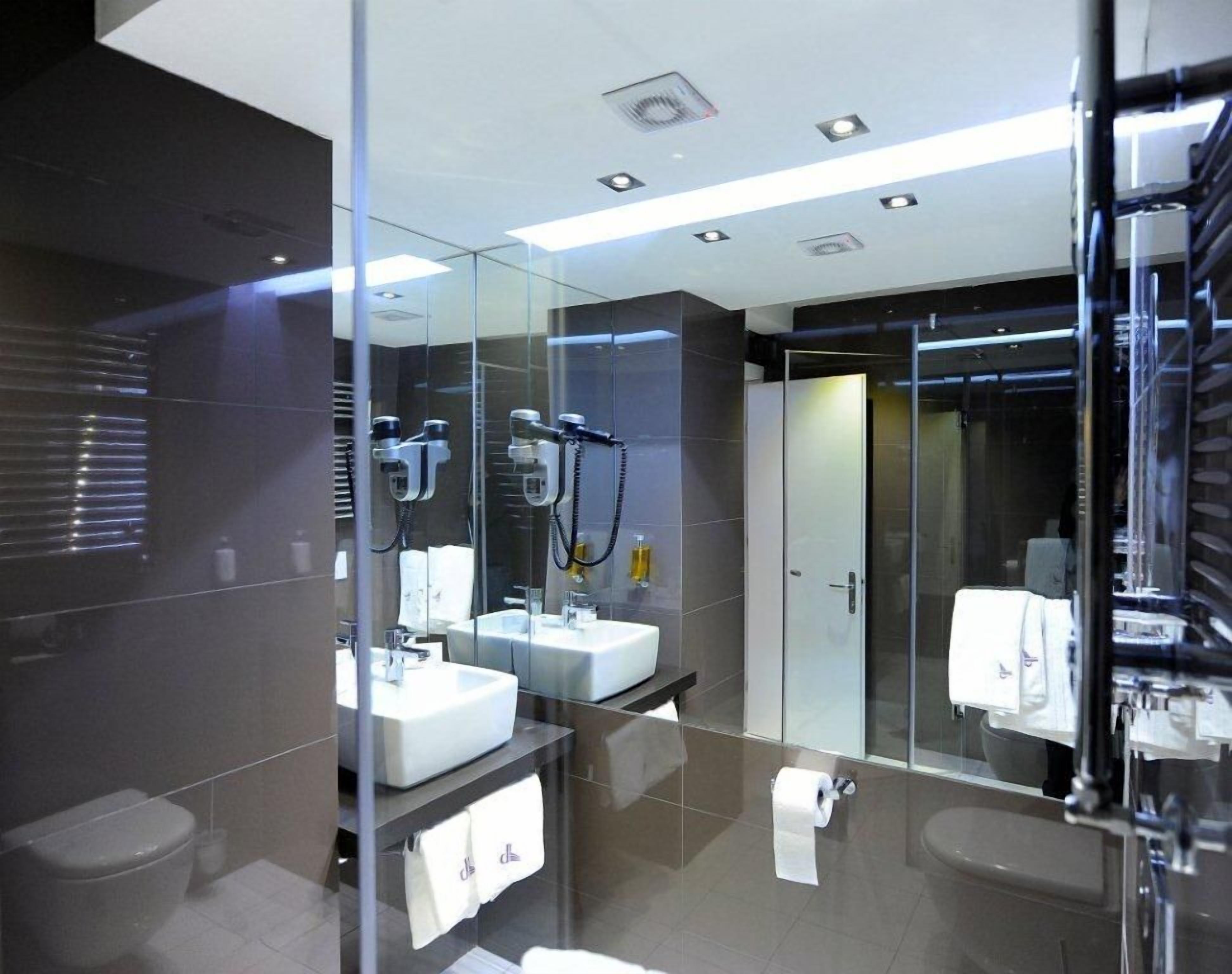 double room single occupancy with king bed | bathroom | shower, hair dryer, towels