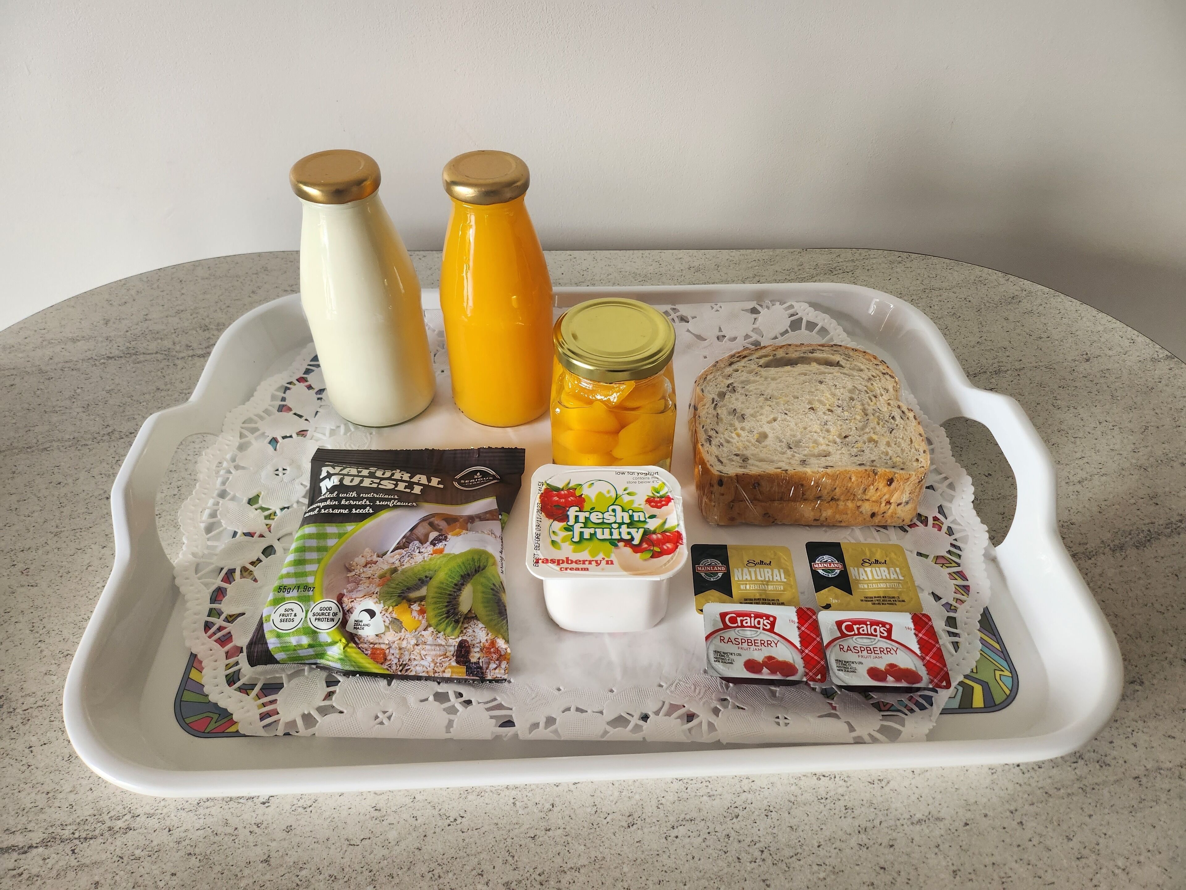 A tray with food items including bread, yogurt, and a drink.