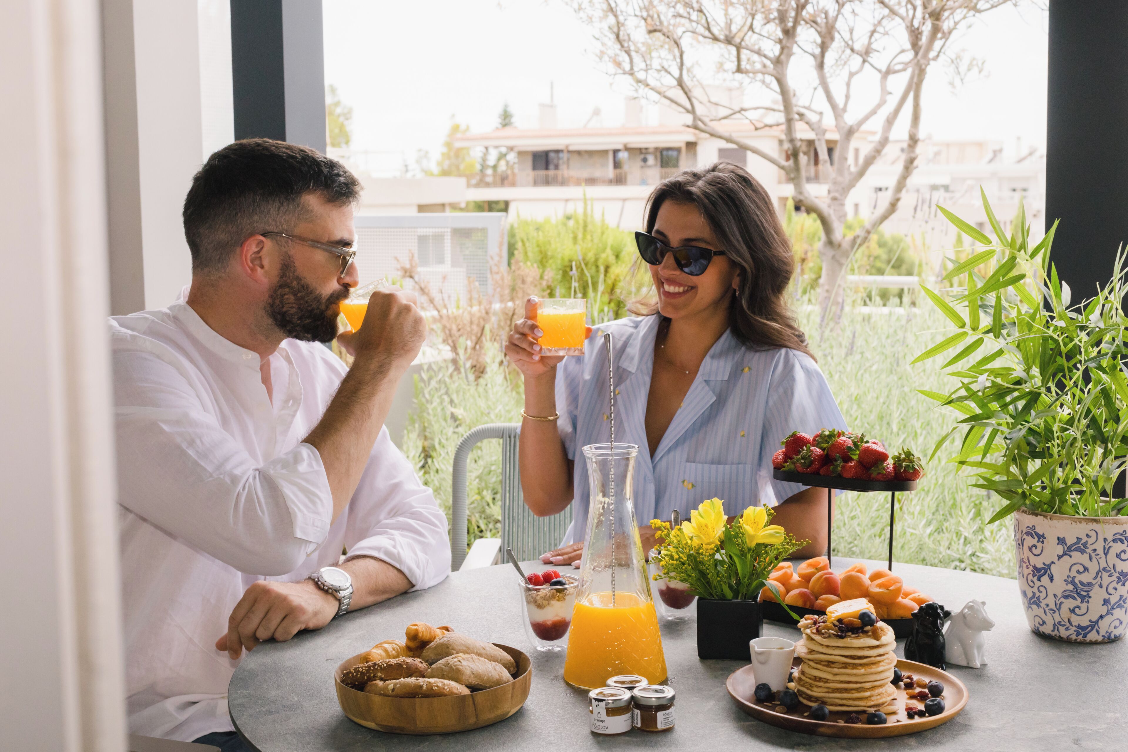 A breakfast setting with a table, food, and drinks.