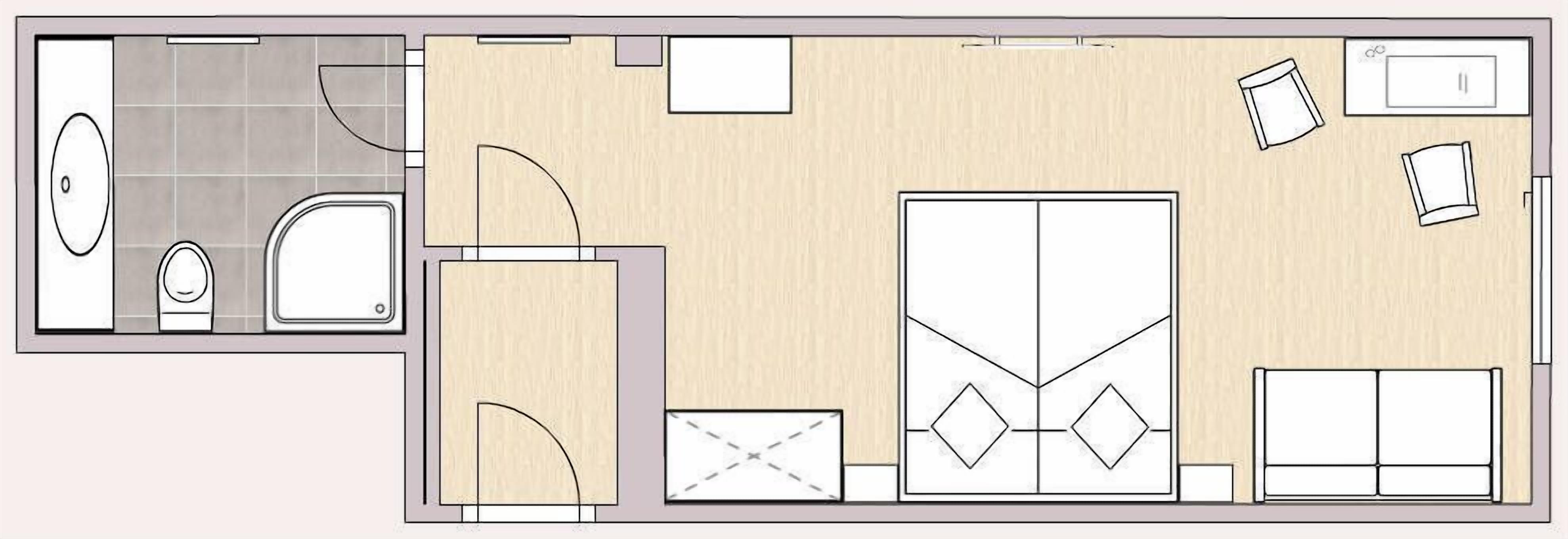 A hotel room layout with a bathroom, a large wardrobe, a bed, and a desk area.