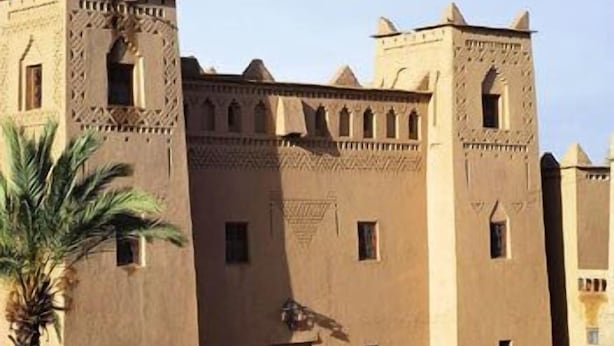 A traditional building with a symmetrical facade, multiple windows, and a central entrance. - Kasbah Dar Essalam (Skoura)