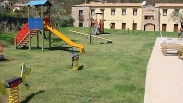 Enjoy family fun in our outdoor play area with a slide and swing set.