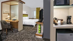 A hotel room with a bed, desk, chair, TV, microwave, coffee maker, and refrigerator. - SpringHill Suites by Marriott San Antonio SeaWorld Lackland (San Antonio)