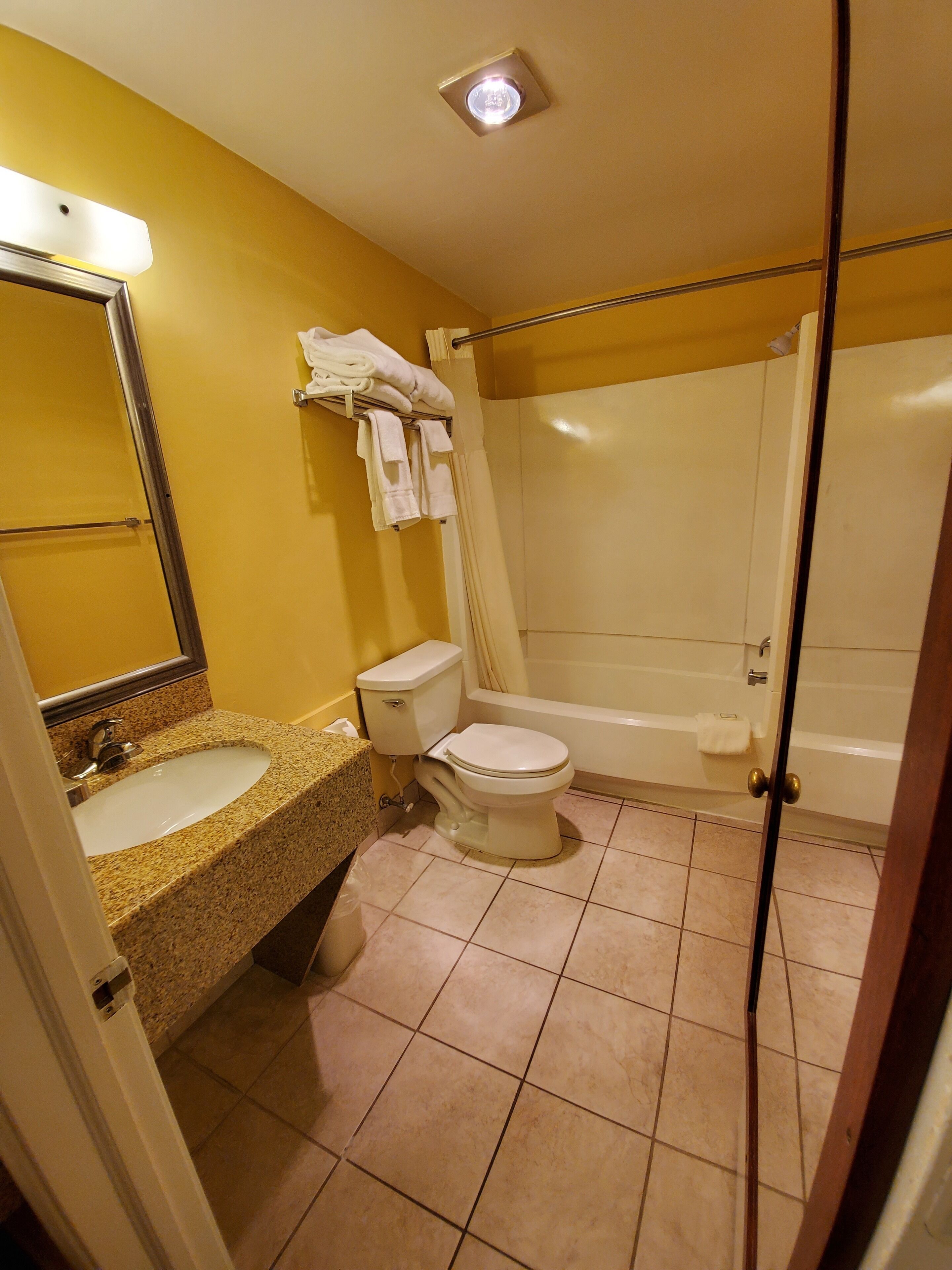 A bathroom with a sink, toilet, and shower.