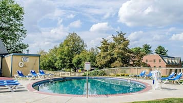 Una piscina al aire libre de temporada, sombrillas