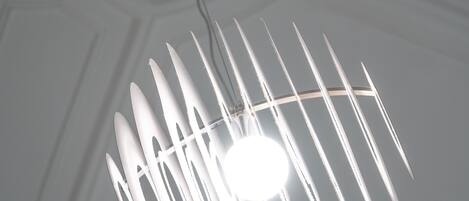 Un plafond orné de motifs décoratifs et un luminaire suspendu.