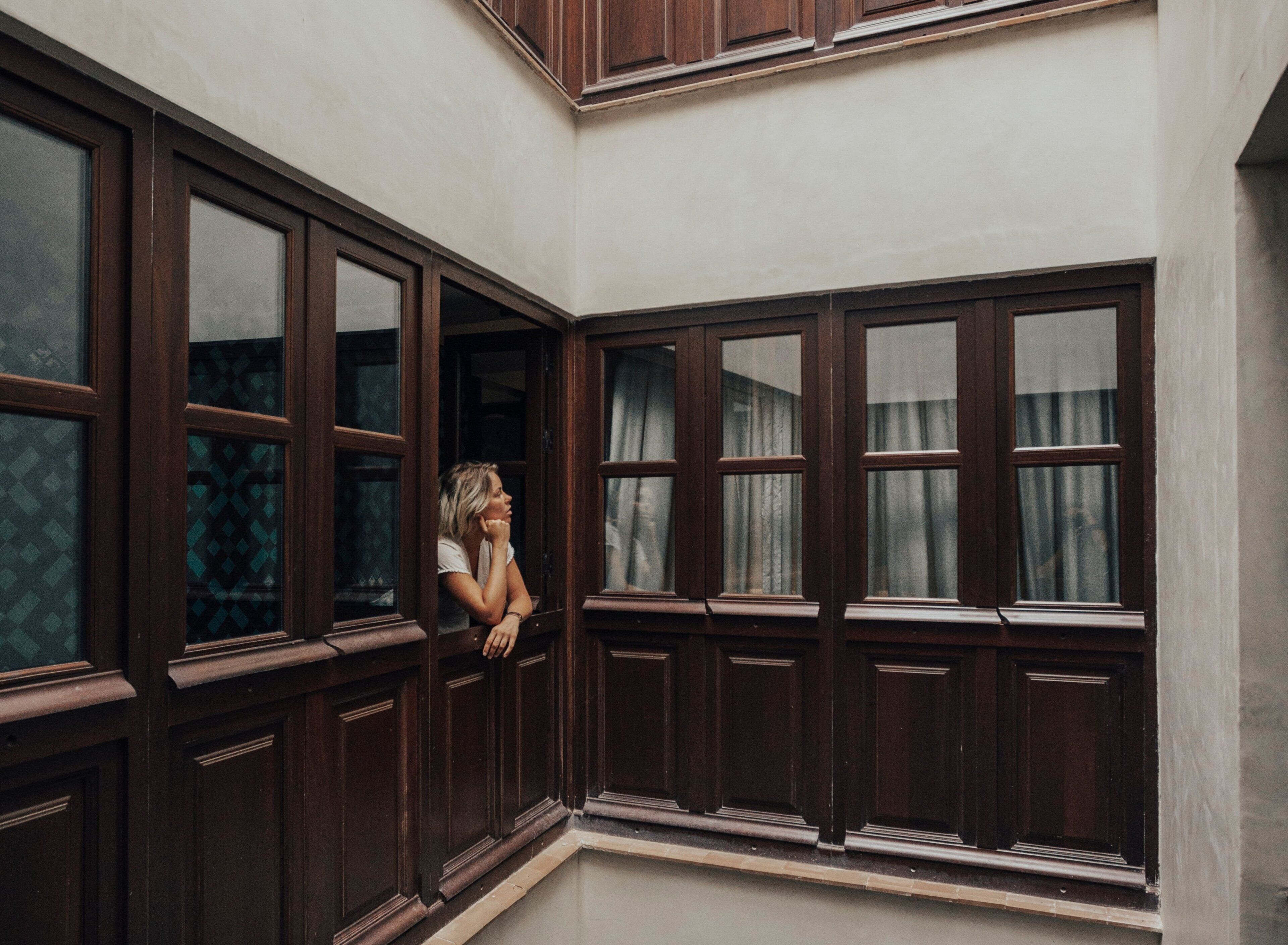 A room with large windows and a view of the outside.