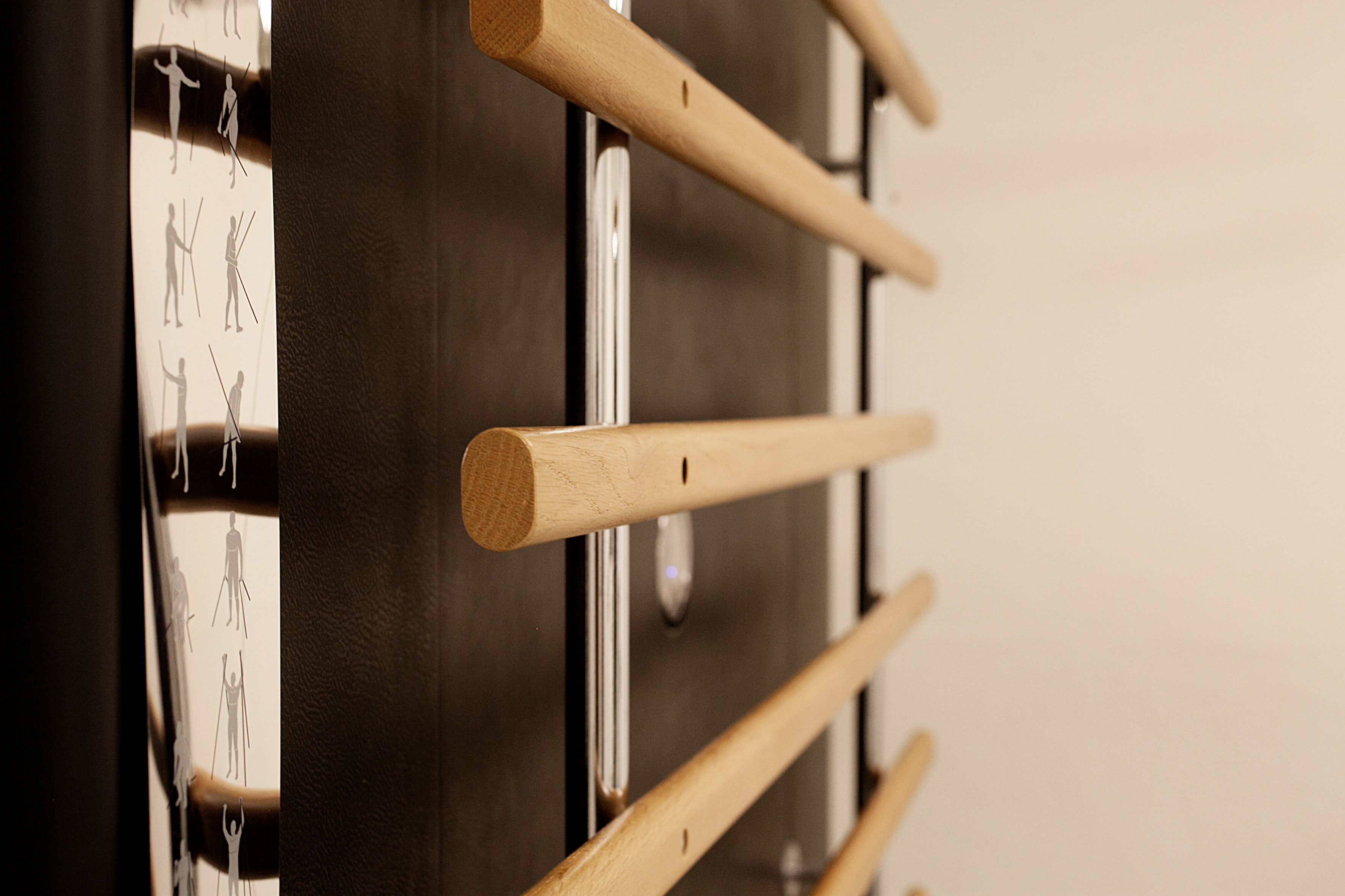 A close-up of a wooden rack with horizontal bars, likely for hanging items.