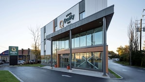 Un hôtel moderne, reconnaissable à son enseigne bien visible indiquant qu’il s’agit d’un Quality Inn.