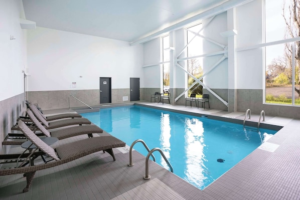 Indoor pool, open 8:00 AM to 10:00 PM, pool loungers