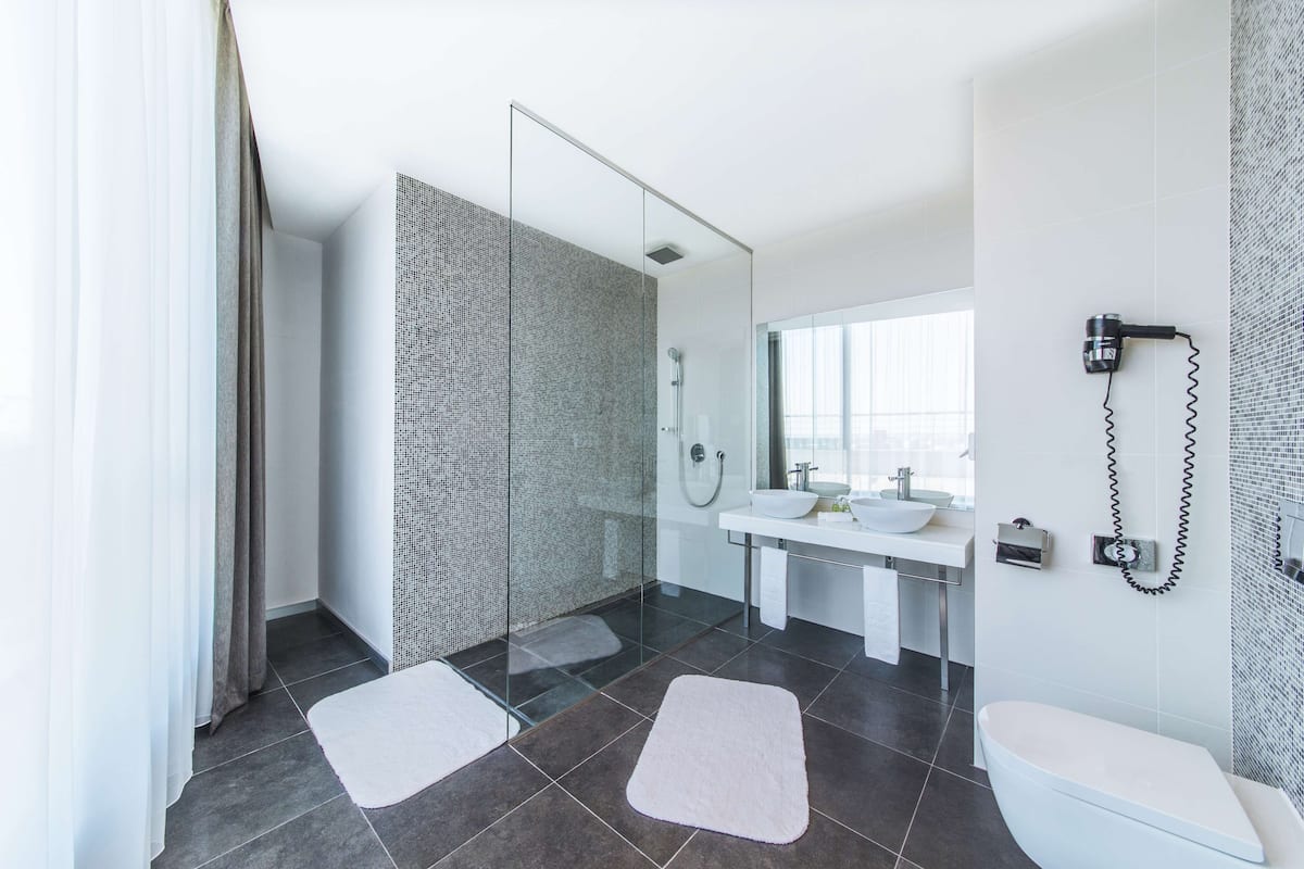 deep-soaking bathtub, rainfall showerhead, eco-friendly toiletries