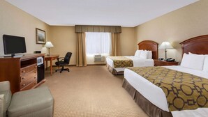 A hotel room with two beds, a desk with a computer, a TV, a chair, and a lamp. - Baymont by Wyndham Fort Morgan (Fort Morgan)