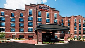 A multi-story brick building with a sign for Fairfield Inn & Suites.
