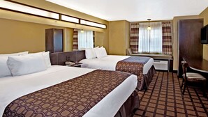 A hotel room with two beds, a desk, a chair, and a television. - Microtel Inn & Suites by Wyndham Cartersville (Cartersville)