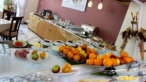 A buffet with various food items and a coffee station. - Europe Hotel (Yerevan)