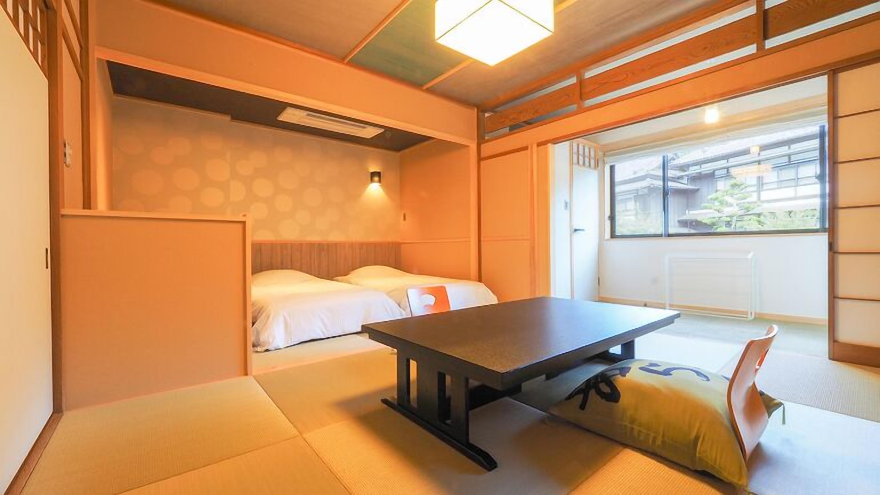 A traditional Japanese room with tatami flooring, a low table, and a bed with white bedding.