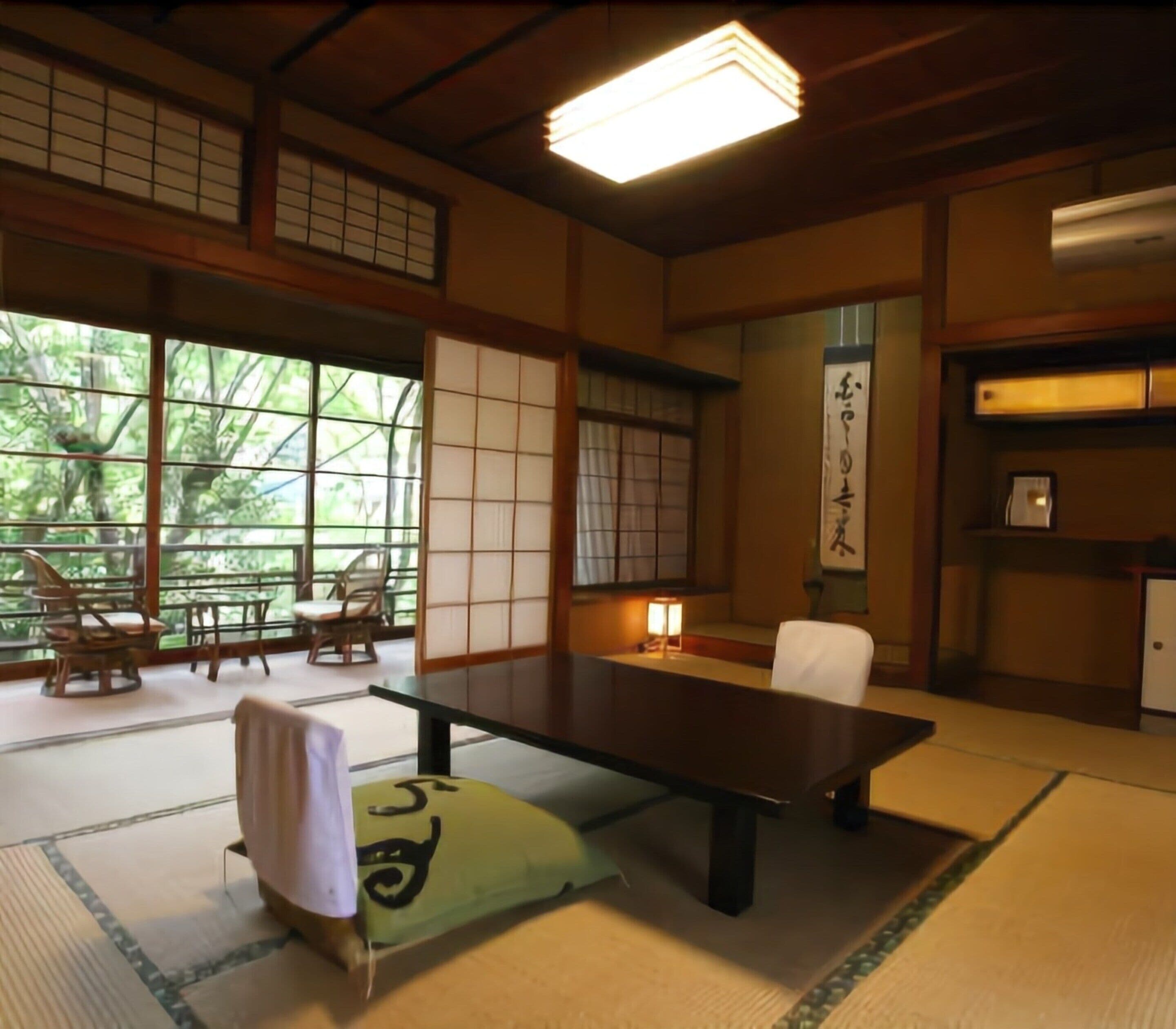 A traditional Japanese room with tatami flooring, a low table, a sofa, and sliding doors.