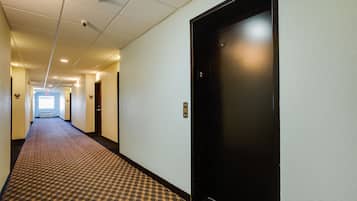 A hotel hallway with a patterned carpet, a black elevator door, and a visible door number '2'.