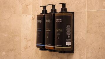 Three bottles of Elemental Herology products on a wall.