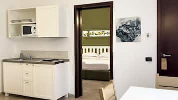 Standard Apartment, 1 Bedroom, Patio | Private kitchenette | Full-size fridge, microwave, stovetop, cookware/dishes/utensils
