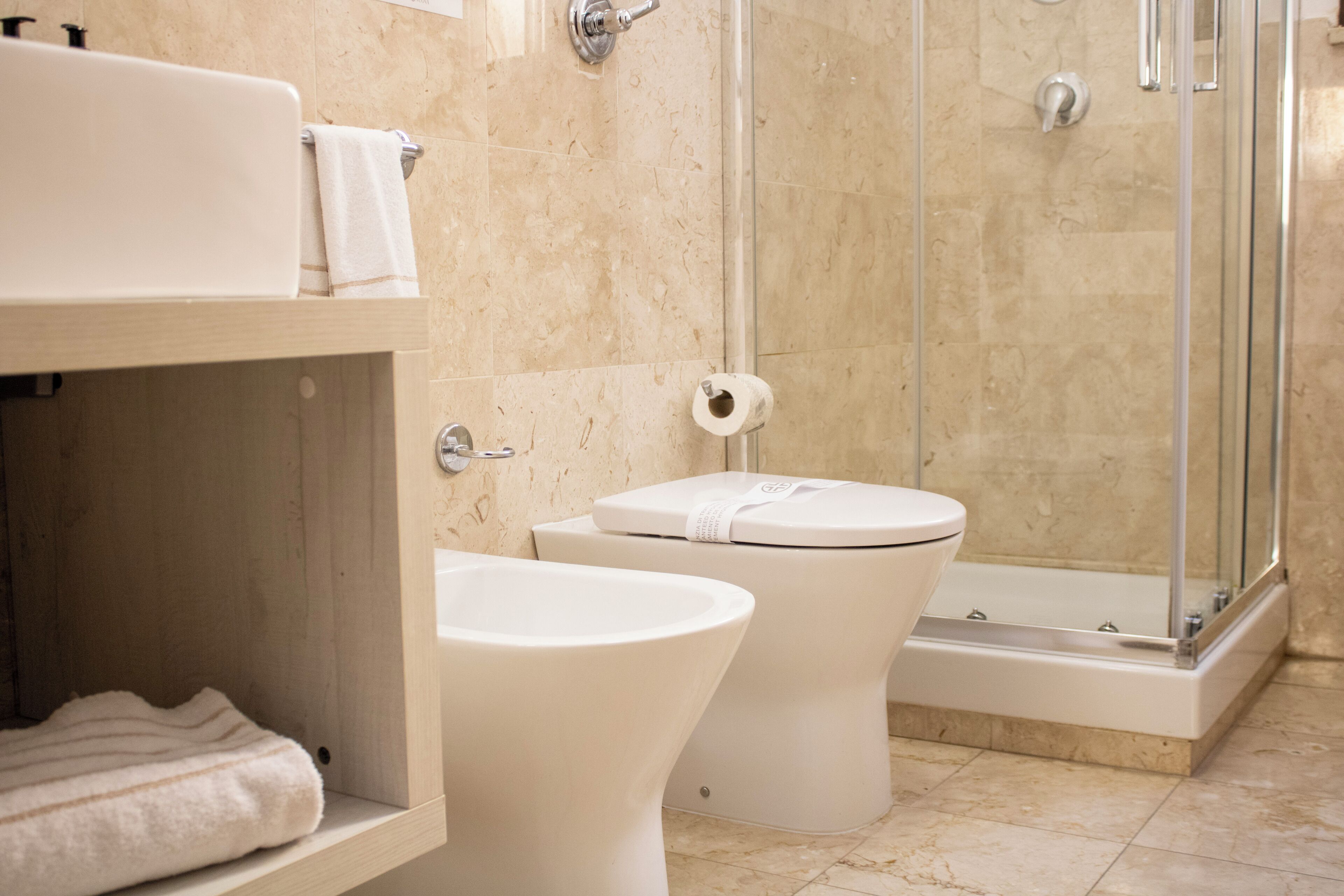 A bathroom with a shower, toilet, and sink.