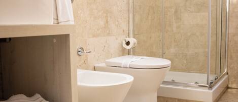 A bathroom with a shower, toilet, and sink.