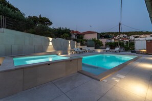 Outdoor pool, a heated pool, pool umbrellas, pool loungers