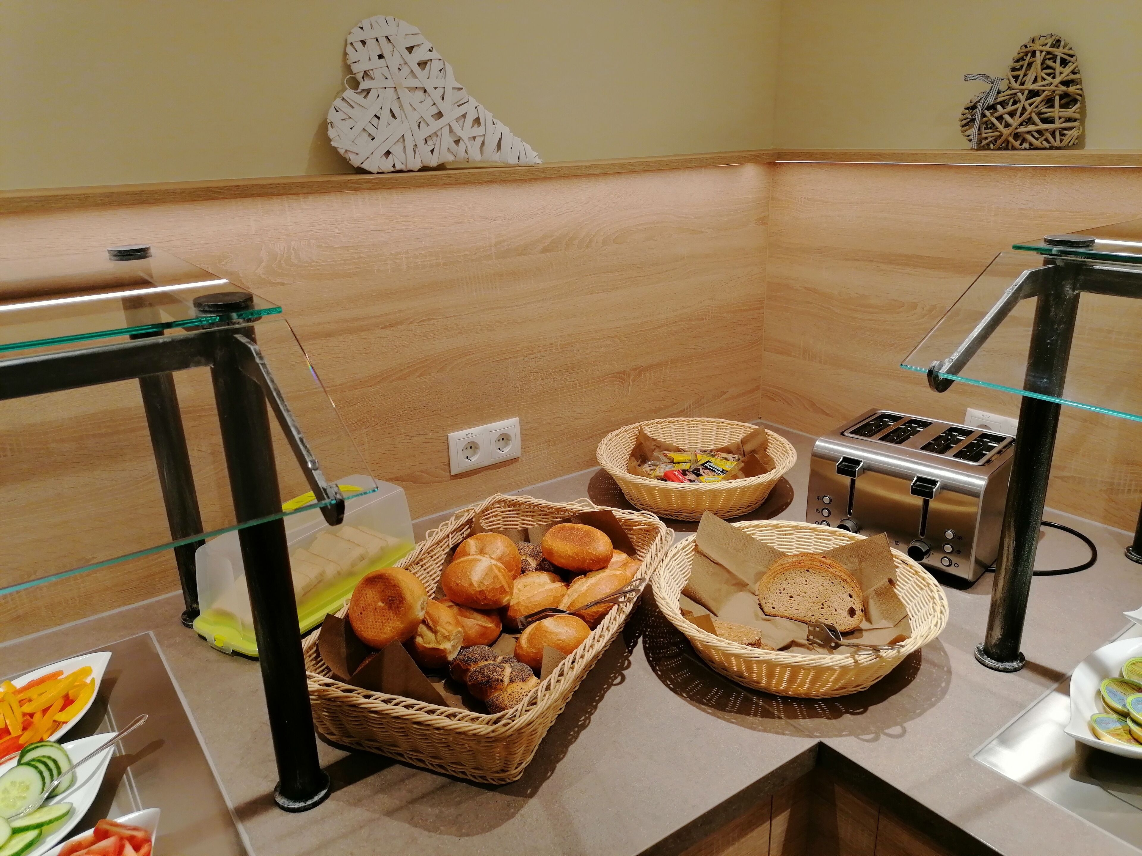 A buffet setup with various food items and a toaster.