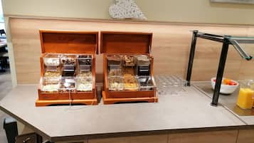 A buffet setup with multiple food dispensers and a drink station.