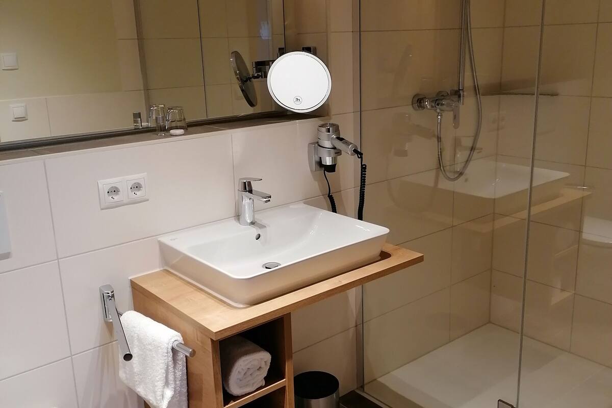 premium double room | bathroom | shower, hair dryer, towels