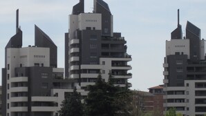 Ένα σύγχρονο πολυώροφο κτίριο με μια ξεχωριστή αρχιτεκτονική, που διακρίνεται από γωνιώδη, εξωτερικά προεξέχοντα τμήματα.