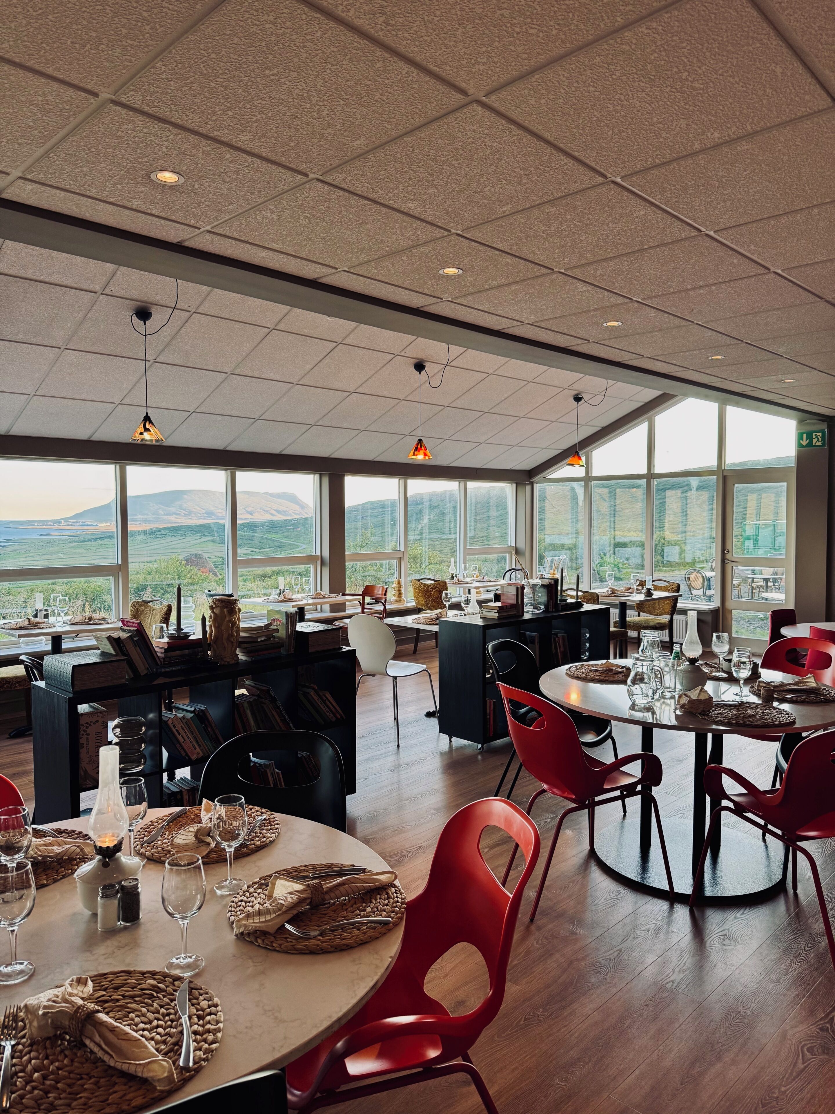 Un comedor espacioso con techos altos, ventanas amplias y vistas al campo.