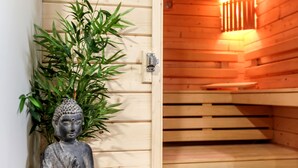 Un sauna en bois, avec un banc et un luminaire fixé au mur.