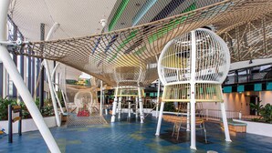 An indoor play area with rope bridges, climbing structures, and a spherical playhouse. - Mercure Sydney Liverpool (Prestons)