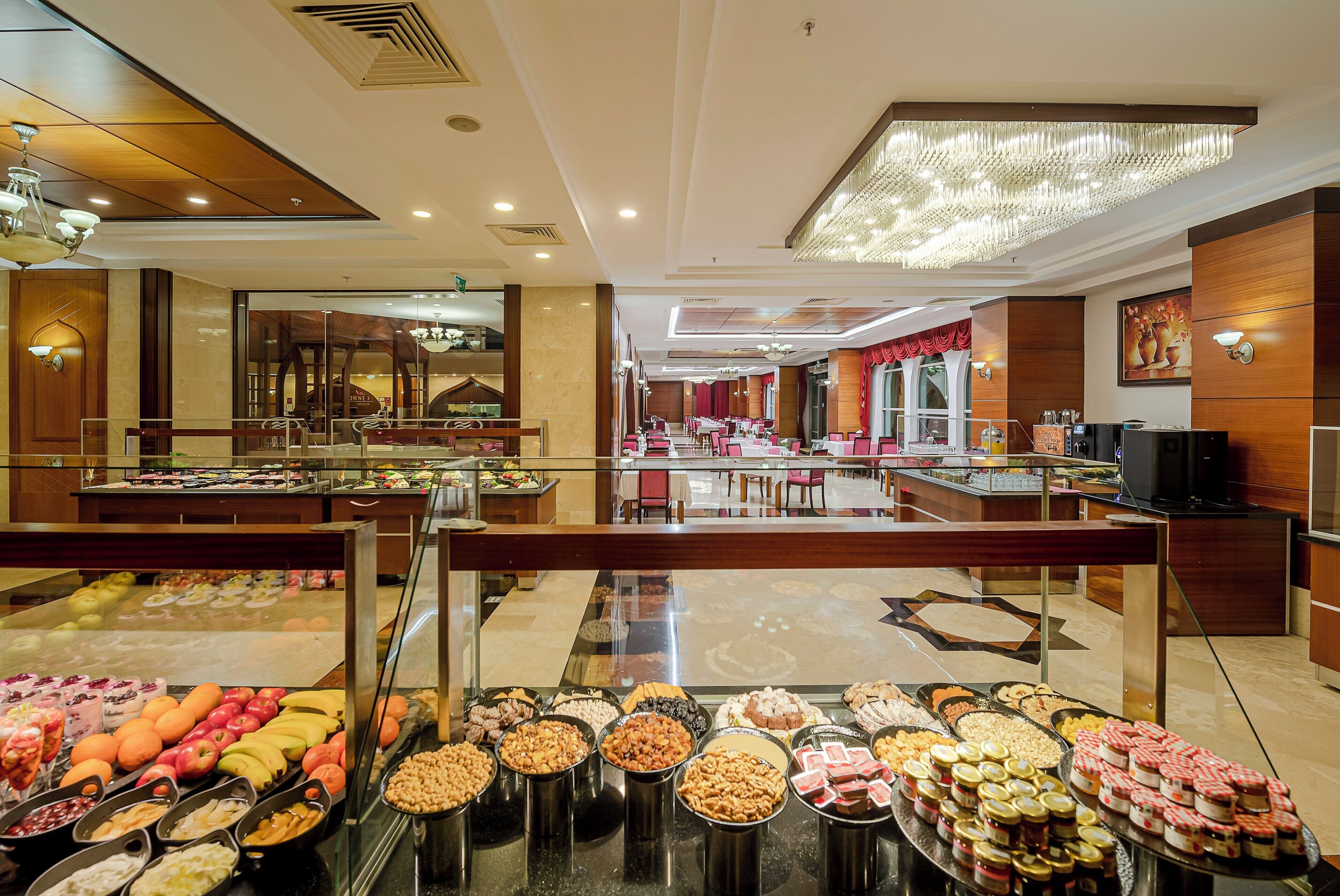 A buffet area with various food options, a seating area with tables and chairs, and a television.