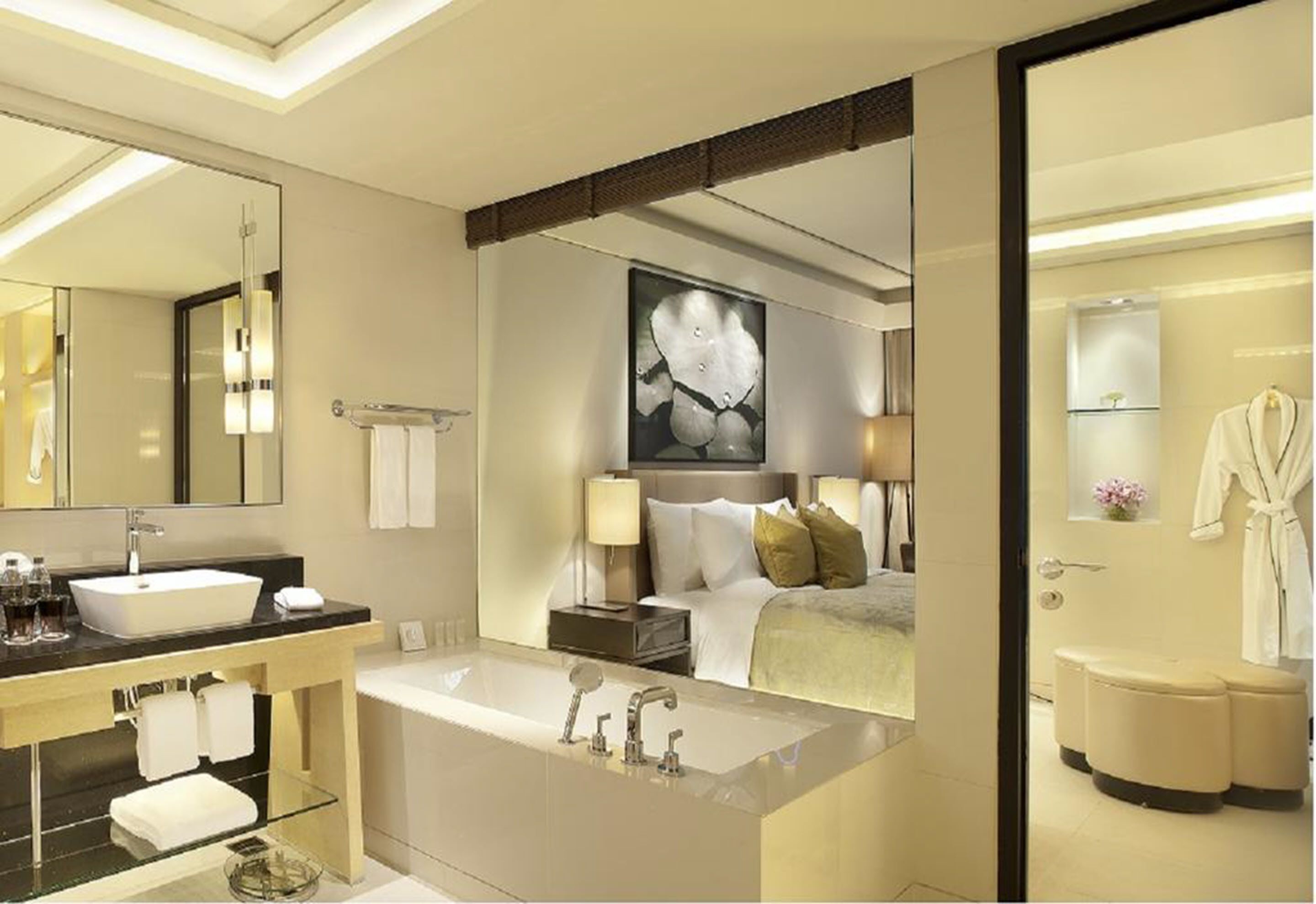 A modern bathroom with a large bathtub, a separate shower area, and a vanity with a mirror and sink.