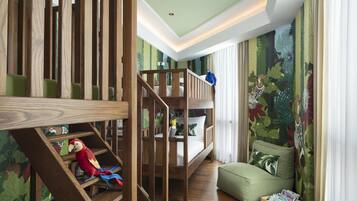 A child's bunk bed with a wooden ladder, a green cushioned bench, and a parrot toy.