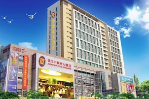 Un hotel de varios pisos con un cartel llamativo del Hotel Zhaotai, Zhuzhou.