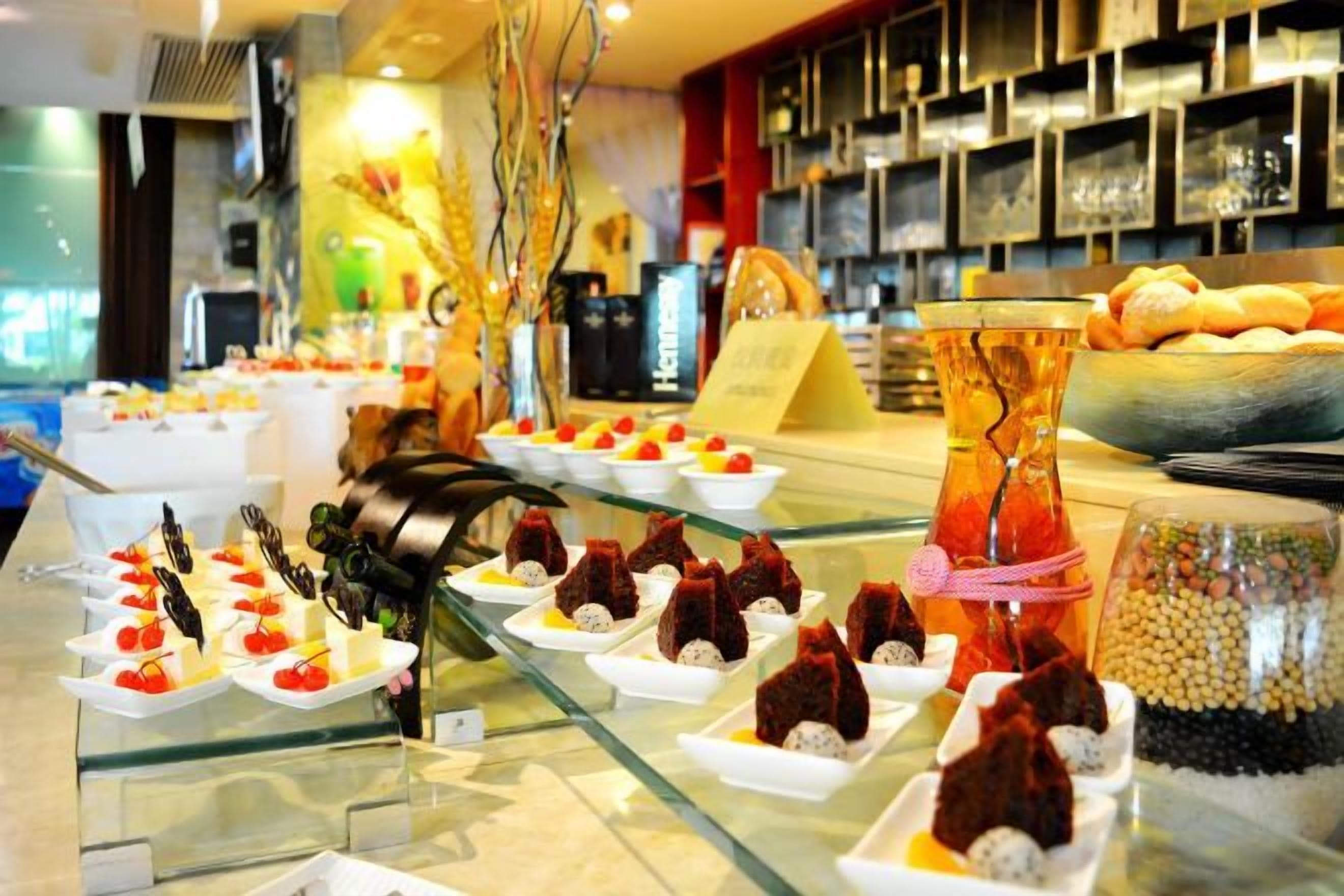 A buffet with various food items and a decorative centerpiece.