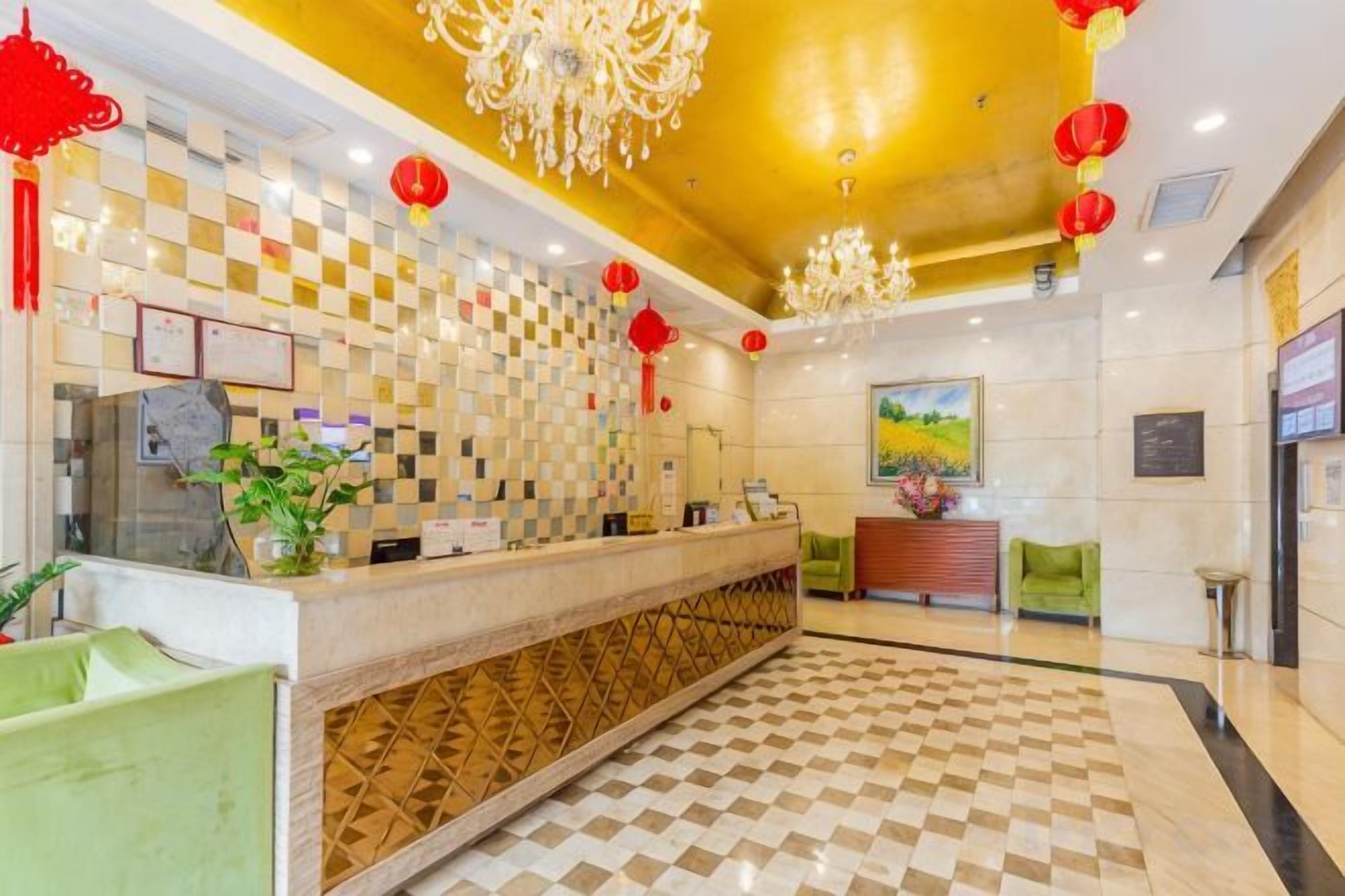 A hotel lobby with a reception desk, check-in counter, and a checkered floor.