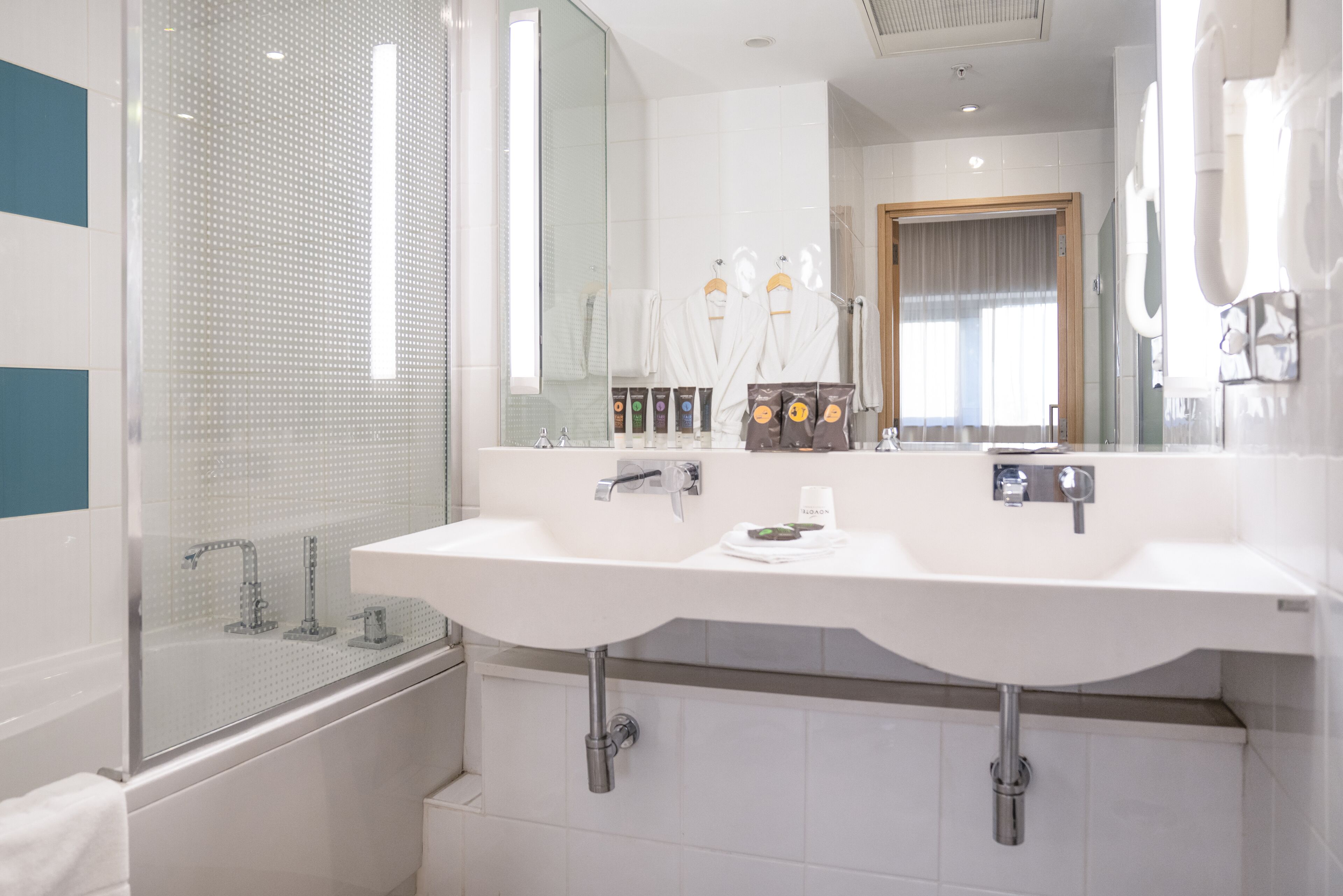 eco-friendly toiletries, hair dryer, slippers, towels